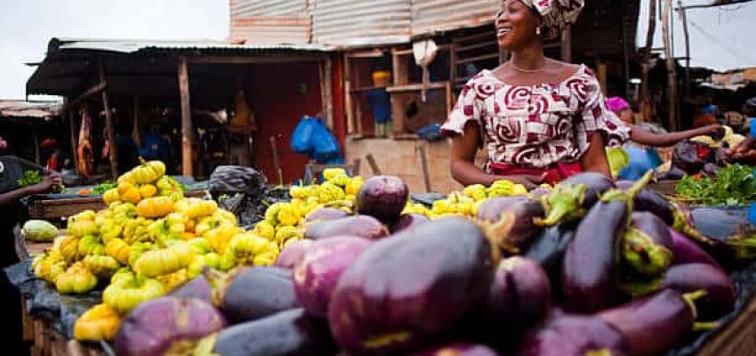 Bamako, Mali - August 1, 2009: Bamako Market where a woman screams and smiles happy to sell some stuff enough to reach the end of the day.